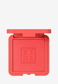 Fard à joues corail vif dans un boîtier carré texturé avec une finition mate. Le couvercle est d'une teinte audacieuse assortie, avec un logo subtil embossé sur le dessus.