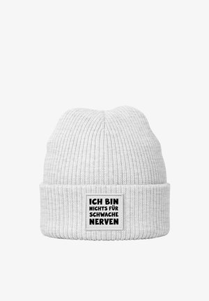 White knit beanie with a ribbed texture. Features a rectangular patch with black text: "ICH BIN NICHTS FÜR SCHWACHE NERVEN."