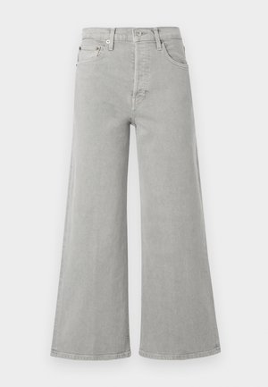 Široké šedé džíny s vysokým pasem. Mezi funkce patří přední kapsy, zip a hnědé kovové detaily.