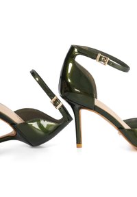Green patent leather high-heeled shoes with ankle straps, peep-toe design, a glossy finish, and a gold buckle accent.