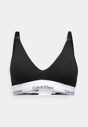 Čierny trojuholníkový podprsenka vyrobená z mäkkej bavlny. Obsahuje nastaviteľné ramienka a biely elastický pás s logom "Calvin Klein".