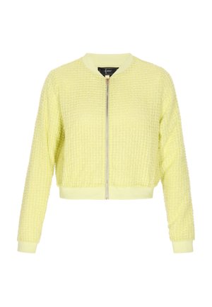Zrezaná bomber bunda v svetložltej farbe, s textúrovanou tkaninou, rebrovanými manžetami, okrúhlym golierom a predným zipsom.