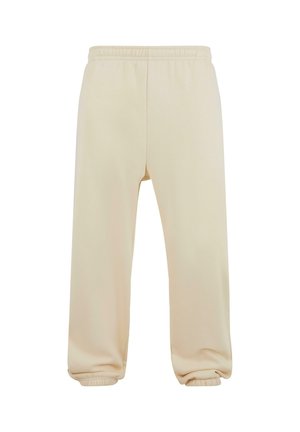 Pantalones de chándal beige con cinturilla elástica, dobladillos ajustados y una textura suave. Diseño simple de pierna recta sin patrones ni adornos.
