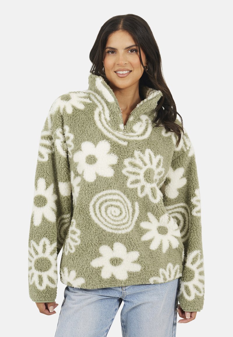 Maglione in pile di colore verde chiaro con motivi floreali e a spirale bianchi, dotato di un alto colletto e design con zip a un quarto.