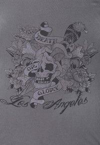 Black graphic design on gray fabric features a skull surrounded by flowers, with ribbons displaying text: "DEATH OR GLORY" and "Los Angeles."