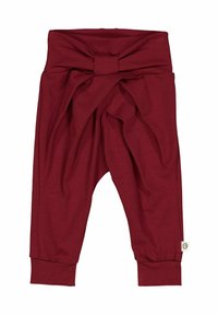 Burgundy pajama pants with a twisted waistband design, made of soft fabric. Features tapered legs with elastic cuffs at the ankles.