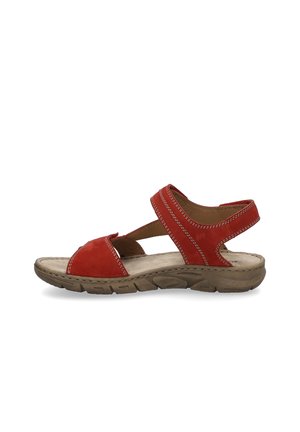 Red suede sandal with a curved design, featuring adjustable straps and a textured rubber sole. Contrast stitching adds a defined detail.