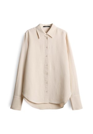 Light beige long-sleeve shirt with a pointed collar, button front, and rounded hem. Made from a smooth, lightweight fabric.