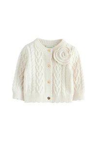 Creme farvet kabelstrikket cardigan med rund halsudskæring, tekstureret mønster og tre træknapper, hvoraf den ene er formet som et hjerte. Blomsterdetalje på skulderen.
