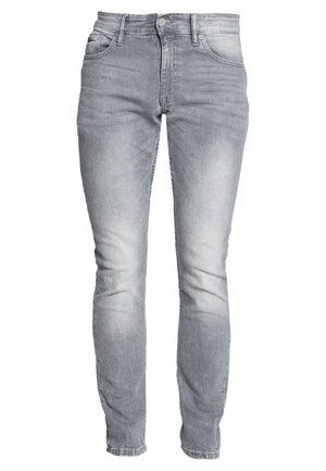 Lichtgrijze denim jeans met een slim fit. Voorzien van voorzakken, een knoopsluiting en subtiele vervaging langs de benen.