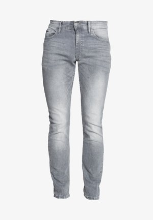 Jasnoszare dżinsy o slim fit. Posiadają kieszenie z przodu, zapięcie na guziki oraz subtelne przetarcia wzdłuż nóg.