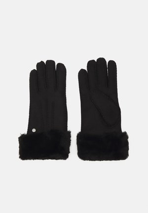 Black leather gloves with fur cuffs. Features include stitched detailing and a silver accent. Soft texture, sleek design.