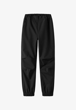 Crne hlače izrađene od glatkog materijala, s elastičnom pasicom, dva bočna džepa i elastičnim manžetama na gležnjevima.