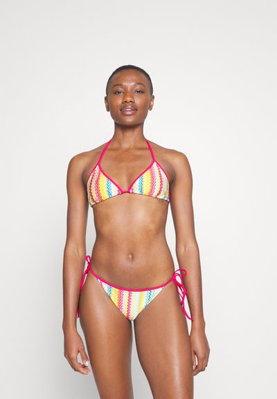 Bikini set featuring a multicolored zigzag pattern in yellow, pink, and blue, with tie straps and a halter neck design.
