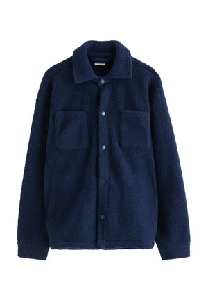 Giacca in pile blu navy con chiusura a bottoni, ampio colletto e due tasche sul petto. Tessuto strutturato con una finitura morbida e pelosa.