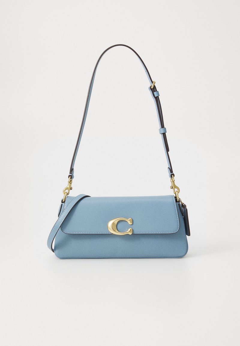 Light blue leather handbag with a fold-over flap, gold hardware, and a detachable shoulder strap. Features a prominent logo accent.