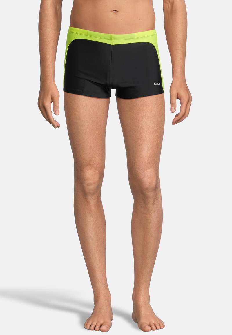 Schwarze Schwimmshorts mit gelbem Akzent am Bund, mit enganliegendem Design und glattem Stoff, geeignet für Wasseraktivitäten.