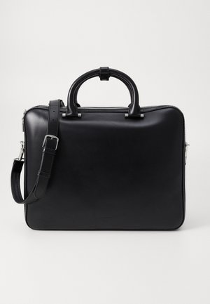 Black leather briefcase with a smooth texture, zip closure, dual top handles, and detachable shoulder strap. Minimalist design with no visible patterns.