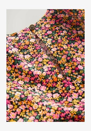 Gėlių suknelė, pasižyminti ryškia daugiakolorine raštu ant juodo fono. Ji turi mygtuko detalę kaklo srityje ir minkštą, tekstūruotą medžiagą.