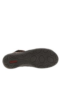 Plantilla negra con una suela de goma texturizada que presenta patrones hexagonales y un logo "rieker" rojo para proporcionar agarre y soporte.