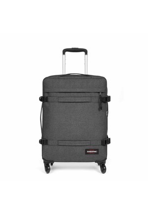 Black fabric suitcase with a textured finish, retractable handle, four wheels, and two adjustable straps. Features an Eastpak logo.