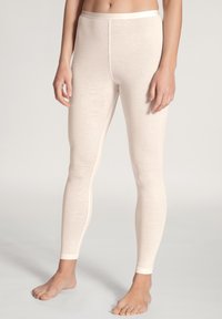 Hellbeige Leggings aus weichem Material, mit einem taillierten Schnitt und einer glatten Textur, ergänzt durch einen kontrastierenden Bund.