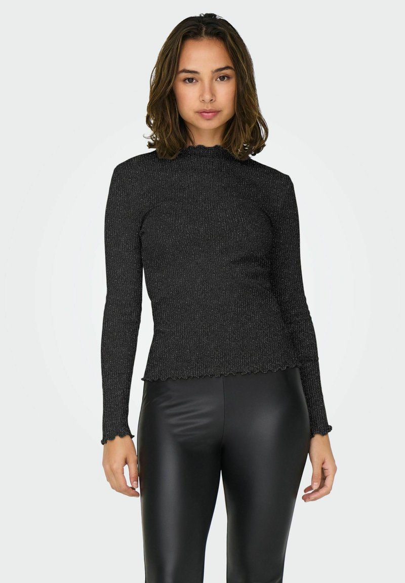 Top lungo a maniche nere a coste con scollatura e orli ondulati, caratterizzato da un design aderente e tessuto testurizzato. Abbinato a leggings neri.