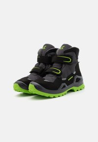 Black and gray hiking boots with green accents and sole. Features Velcro straps and textured fabric for grip and support. Durable design.