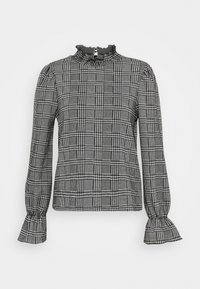 Blusa in bianco e nero a motivo houndstooth con collo alto arricciato, maniche lunghe e polsini arricciati. Realizzata in tessuto testurizzato con una vestibilità strutturata.