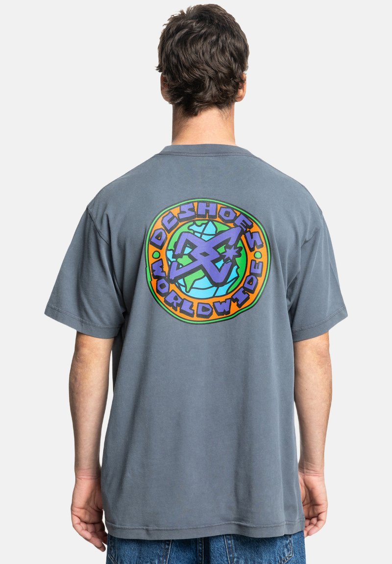 Gray cotton t-shirt with short sleeves, featuring a colorful circular logo on the back that includes the text "DC Shoes Worldwide."