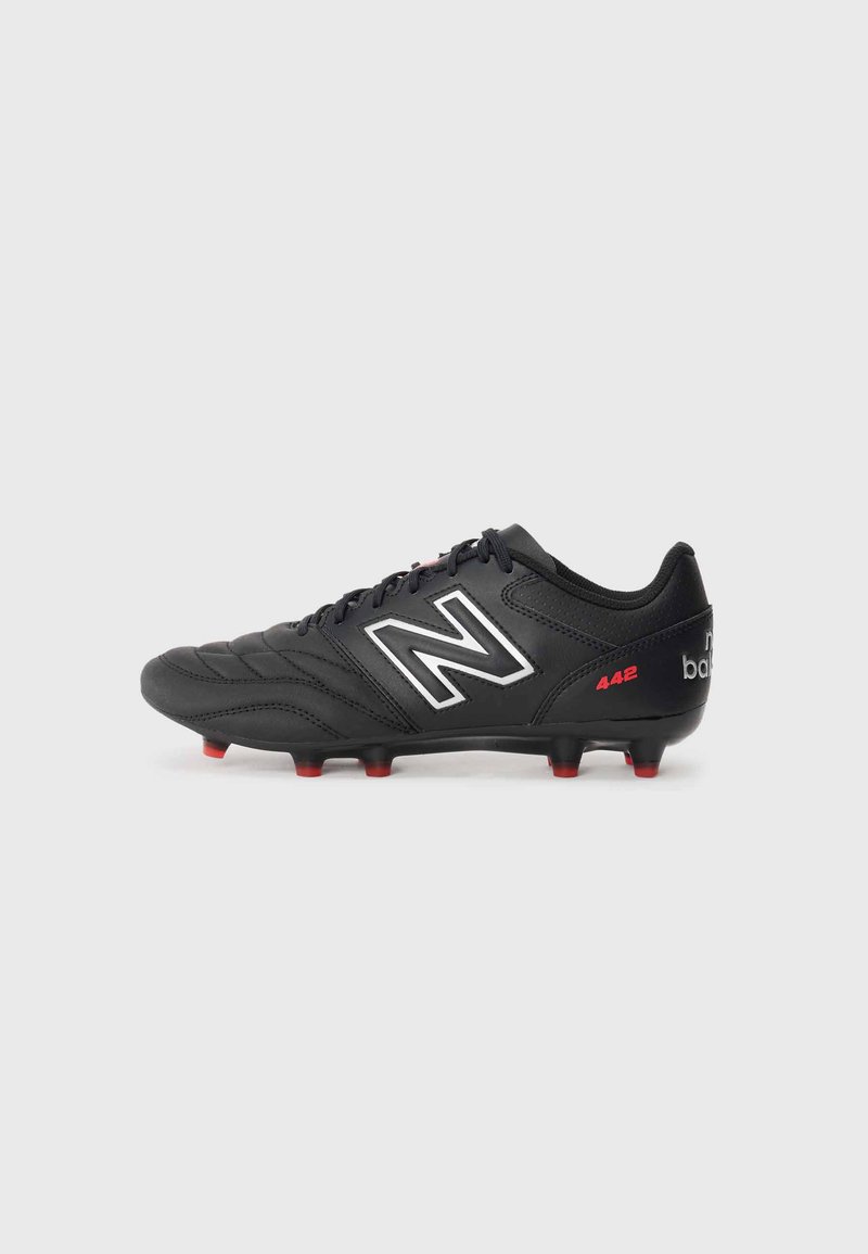 Black soccer cleat in synthetic material with white logo, red accents, textured upper, and multiple red studs on base for traction.