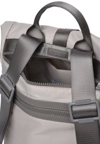 Mochila gris con tejido liso y texturizado. Cuenta con una asa superior, correas de hombro ajustables y un bolsillo con cremallera en la parte frontal.
