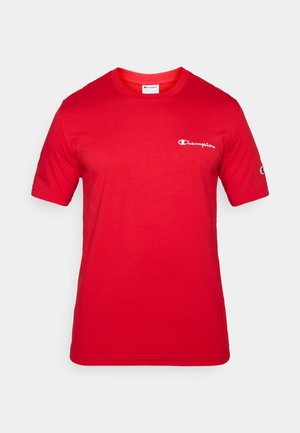 Crvena pamučna majica kratkih rukava, rebrasti okrugli izrez i mali bijeli logo "Champion" na prsištu i rukavu. Mekana tekstura.