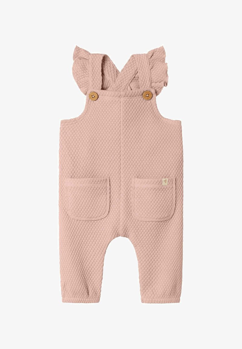 Overoles rosados texturizados con tirantes con volantes, botones de madera y dos bolsillos frontales. Confeccionados en un material suave y transpirable.