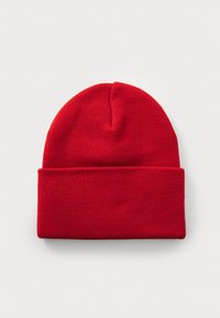 Red knit beanie with a folded cuff, made from soft, textured material. Features a rounded top and seamless design.