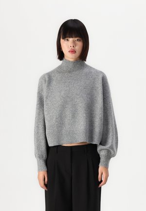 Gray, cropped sweater with a high, ribbed collar and balloon sleeves. Made of soft knit material, featuring a ribbed hemline.