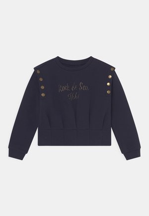 Marineblå cropped sweatshirt med lange ærmer, knapdetaljer på skuldrene og "Rock & Sea" broderet på brystet.