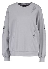 Gray sweatshirt featuring a crew neck, oversized design, ribbed cuffs, and distressed detailing on both sleeves and front.
