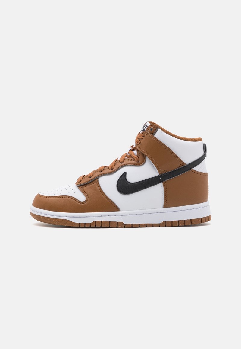 Brown and white high-top sneakers with perforated toe, black Nike swoosh, and textured brown accents. White sole with a rubber outsole.