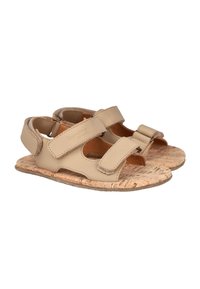 Sandalias de cuero beige con dos correas de Velcro ajustables, plantilla de corcho y lados con cortes para transpirabilidad. Suela plana con superficie texturizada.