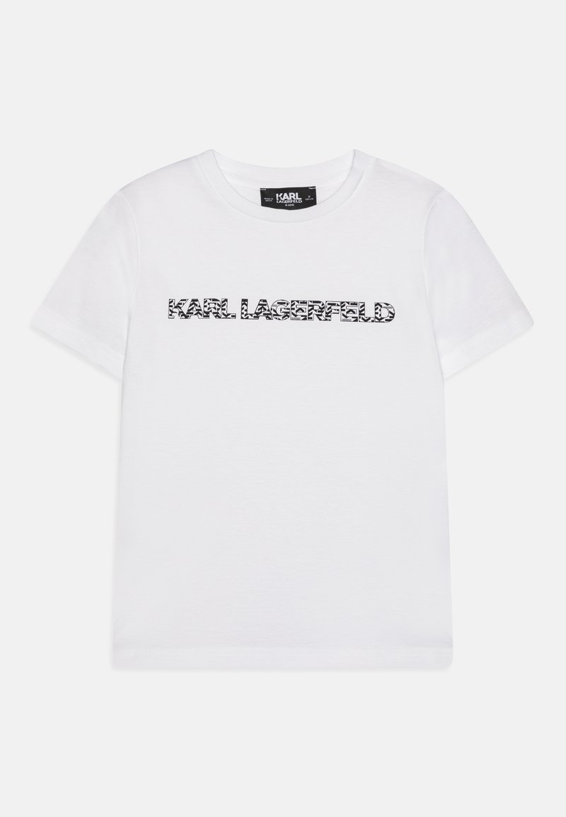 T-shirt en coton blanc avec un imprimé graphique noir de "KARL LAGERFELD" dans une police audacieuse et contemporaine. Manches courtes et col rond.