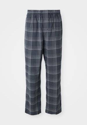 Marineblauwe en witte geblokte pyjamabroek met een elastische tailleband, tentoongesteld tegen een effen witte achtergrond.