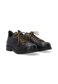 Schwarze Leder Schnürschuhe mit hellbraunen Schnürsenkeln. Abgerundete Spitze, flacher Absatz und eine genähte Verzierung um die Sohle. Glatte Textur.