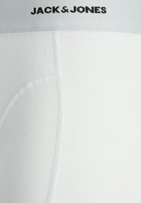 White cotton boxer briefs with a soft waistband featuring "JACK & JONES" logo in black. Smooth texture and fitted design.