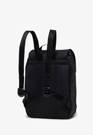 Black backpack with padded fabric, adjustable straps, and top handle. Rectangular shape with a smooth texture and simple design.