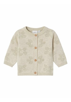 Cardigan lavorato a maglia beige con motivo floreale, scollatura rotonda, maniche lunghe e bottoni di legno sulla parte anteriore. Texture morbida e leggera.