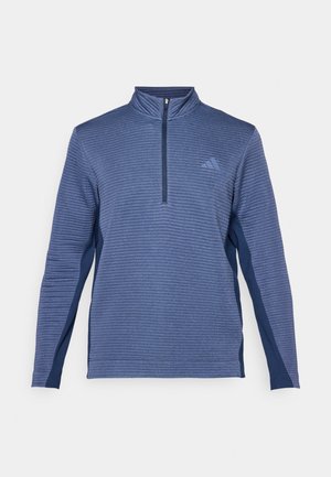 Blå långärmad sportpullover med ribbad textur, hög krage, halvmeterdragkedja och subtil logotyp på vänster bröst.