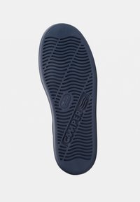 Navy rubber shoe sole featuring wavy traction patterns and embossed "CAMPER" logo, with a smooth edge and rounded toe area.