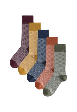 Set of five socks in varying colors: burgundy, mustard, navy, terracotta, and olive. Features ribbed tops and textured patterns.