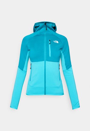 Hooded jacket featuring a color block design in shades of turquoise, made from soft, stretchable fabric; includes zippered pockets.